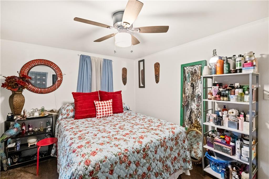 718 Gladden Road Canonsburg, PA 15317 - Photo 21 of 28 a bedroom with a bed a books bucket with a large mirror and a fan