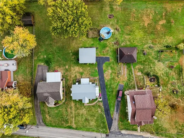 an aerial view of a house with garden space and sitting space