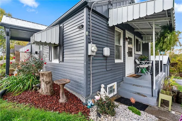 a view of a chairs and table in backyard of the house