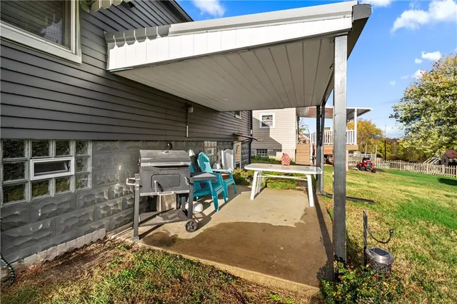 a view of a patio with table and chairs with wooden floor and fence