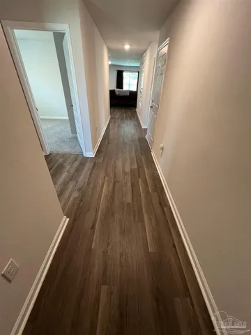 a view of gallery with wooden floor