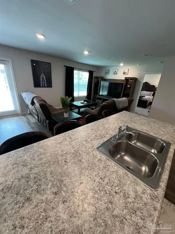 a kitchen with stainless steel appliances kitchen island granite countertop a sink and a stove top oven