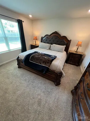 a bedroom with a bed and window