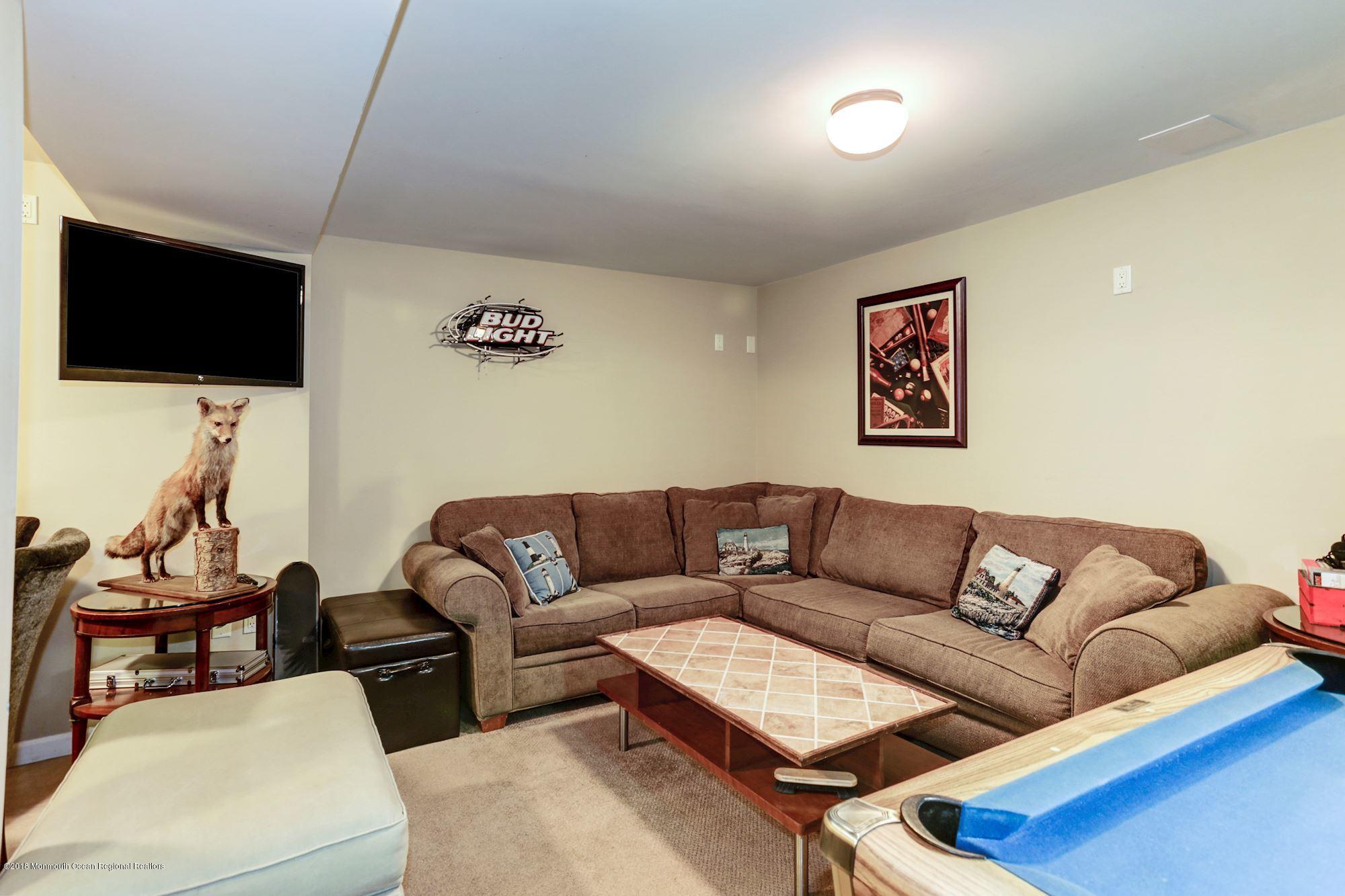 132 Brandon Road Manchester Township, NJ 08759 - Photo 15 of 24 a living room with furniture and a flat screen tv