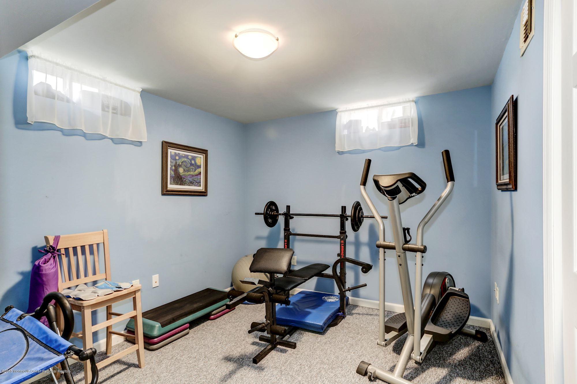 132 Brandon Road Manchester Township, NJ 08759 - Photo 17 of 24 a room with gym equipment and windows