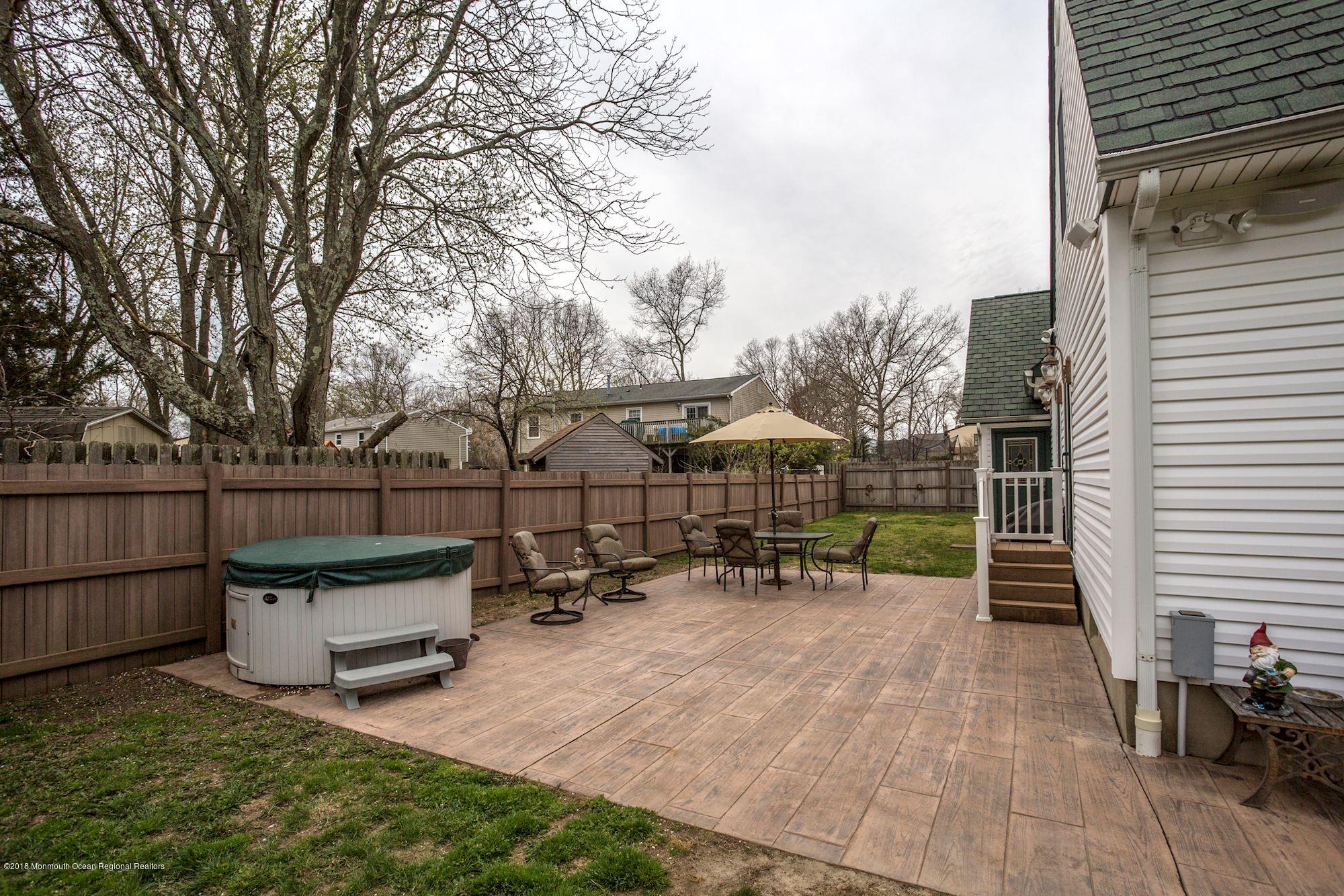 132 Brandon Road Manchester Township, NJ 08759 - Photo 22 of 24 a view of a chair and table in the back yard of the house