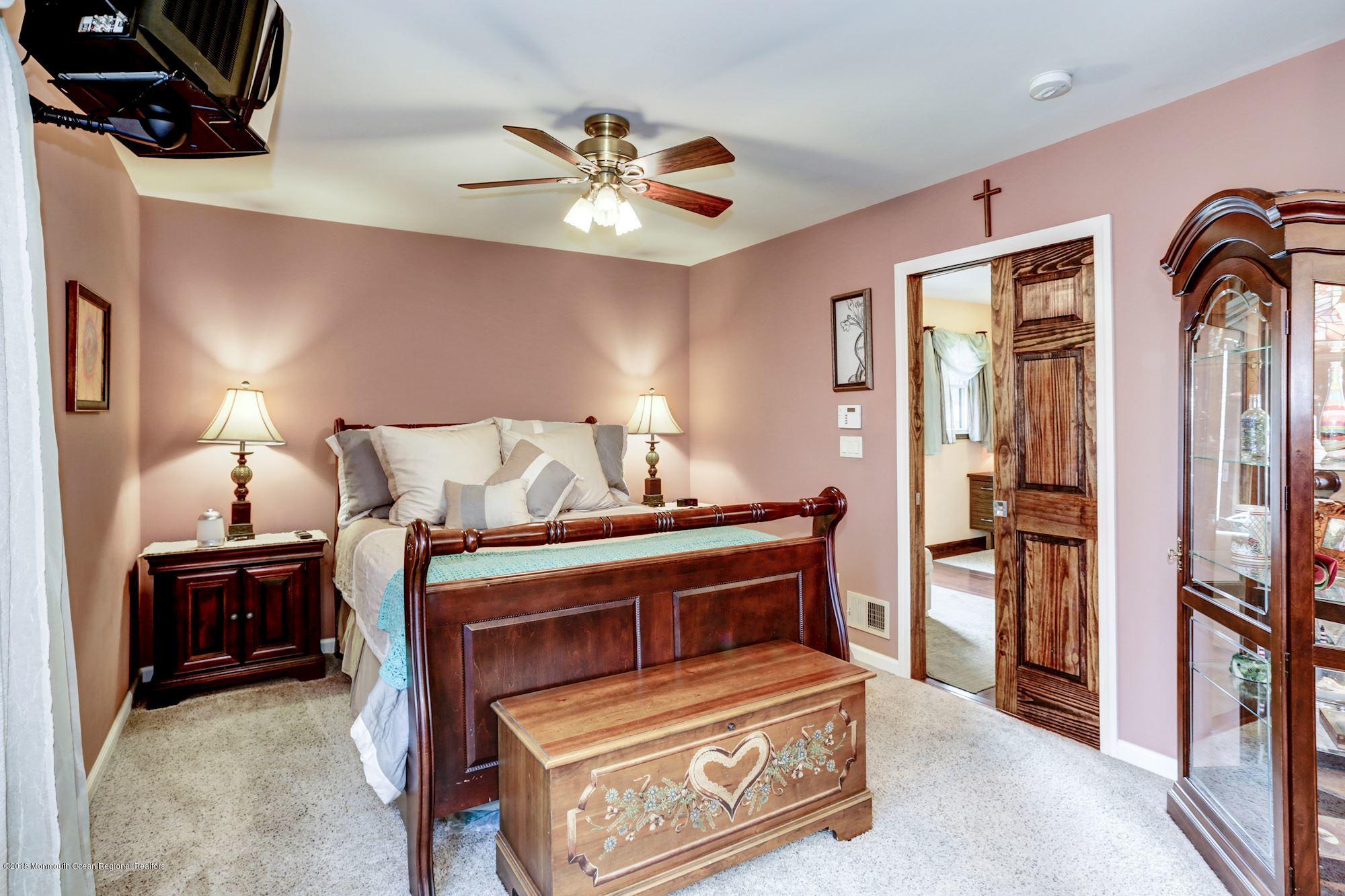 132 Brandon Road Manchester Township, NJ 08759 - Photo 7 of 24 a bedroom with a bed and a chandelier