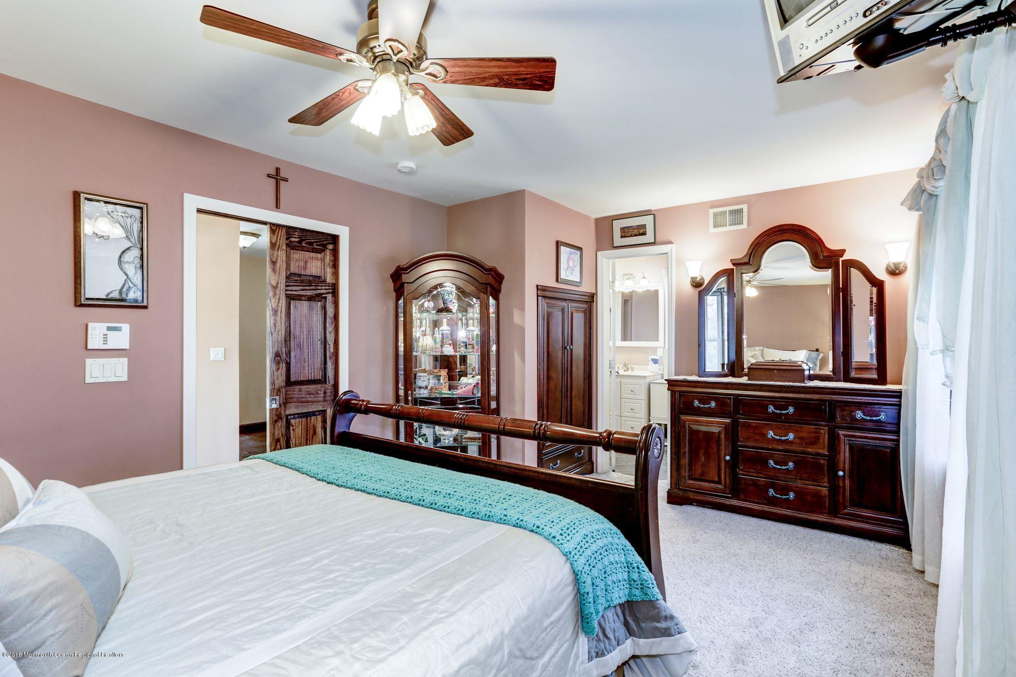 132 Brandon Road Manchester Township, NJ 08759 - Photo 8 of 24 a bedroom with a bed a dresser and mirror