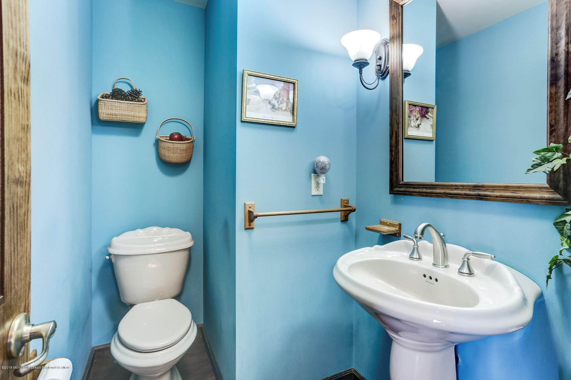132 Brandon Road Manchester Township, NJ 08759 - Photo 10 of 24 a bathroom with a toilet a sink and mirror