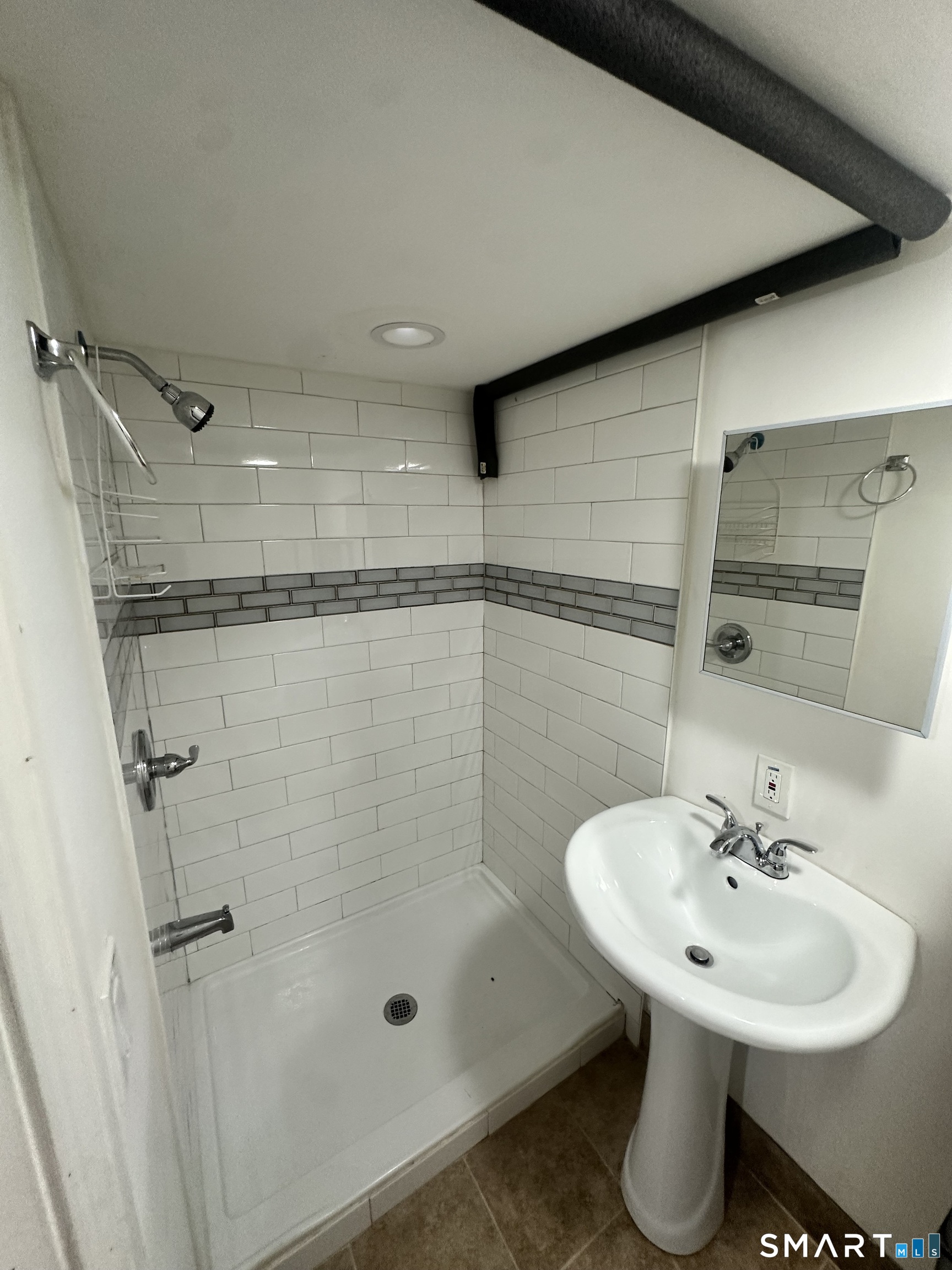 302 Dover Street Bridgeport, CT 06610 - Photo 32 of 40 a bathroom with a shower sink and mirror