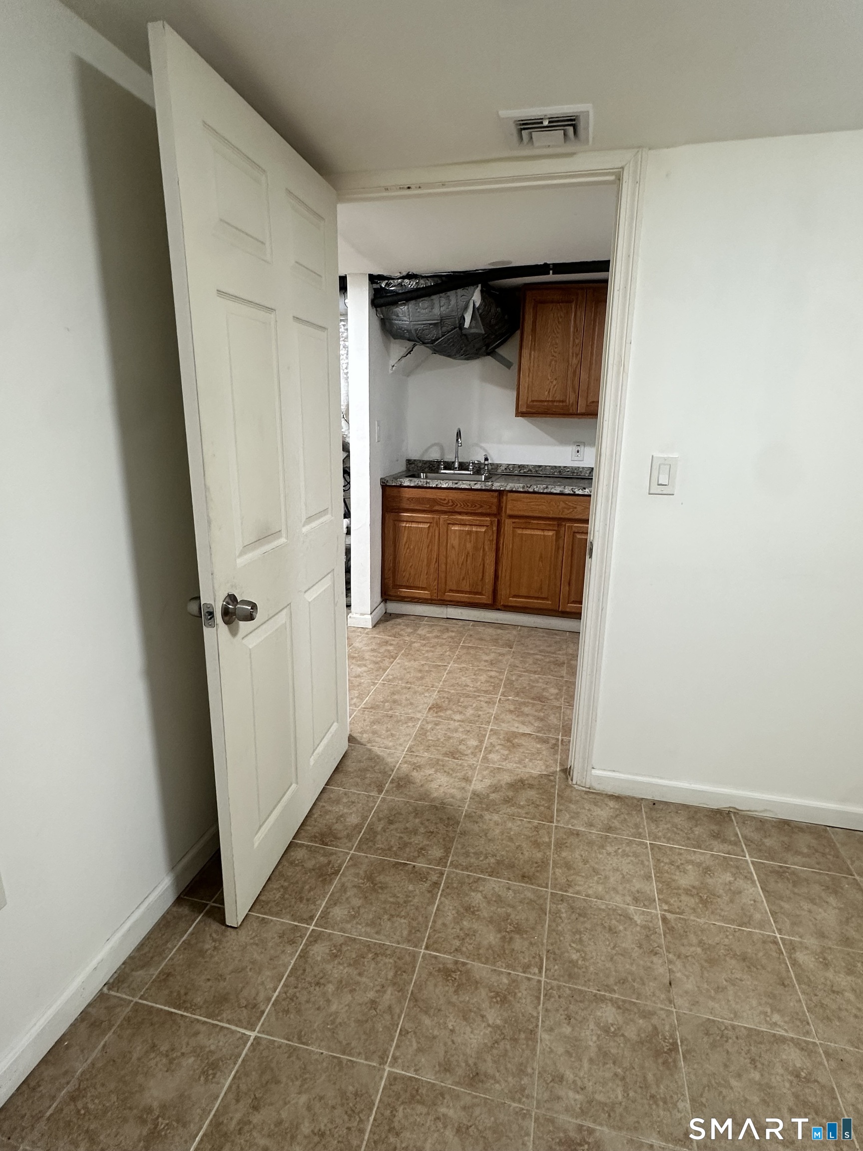302 Dover Street Bridgeport, CT 06610 - Photo 35 of 40 a kitchen with granite countertop a sink and a stove top oven