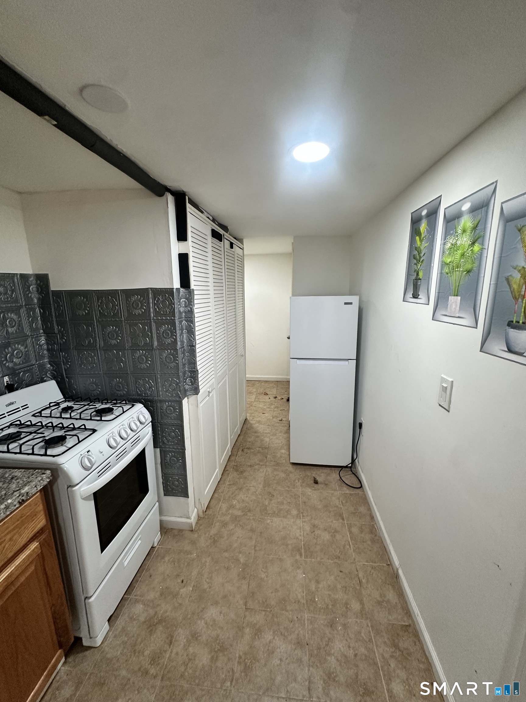 302 Dover Street Bridgeport, CT 06610 - Photo 37 of 40 a kitchen with a stove and a refrigerator