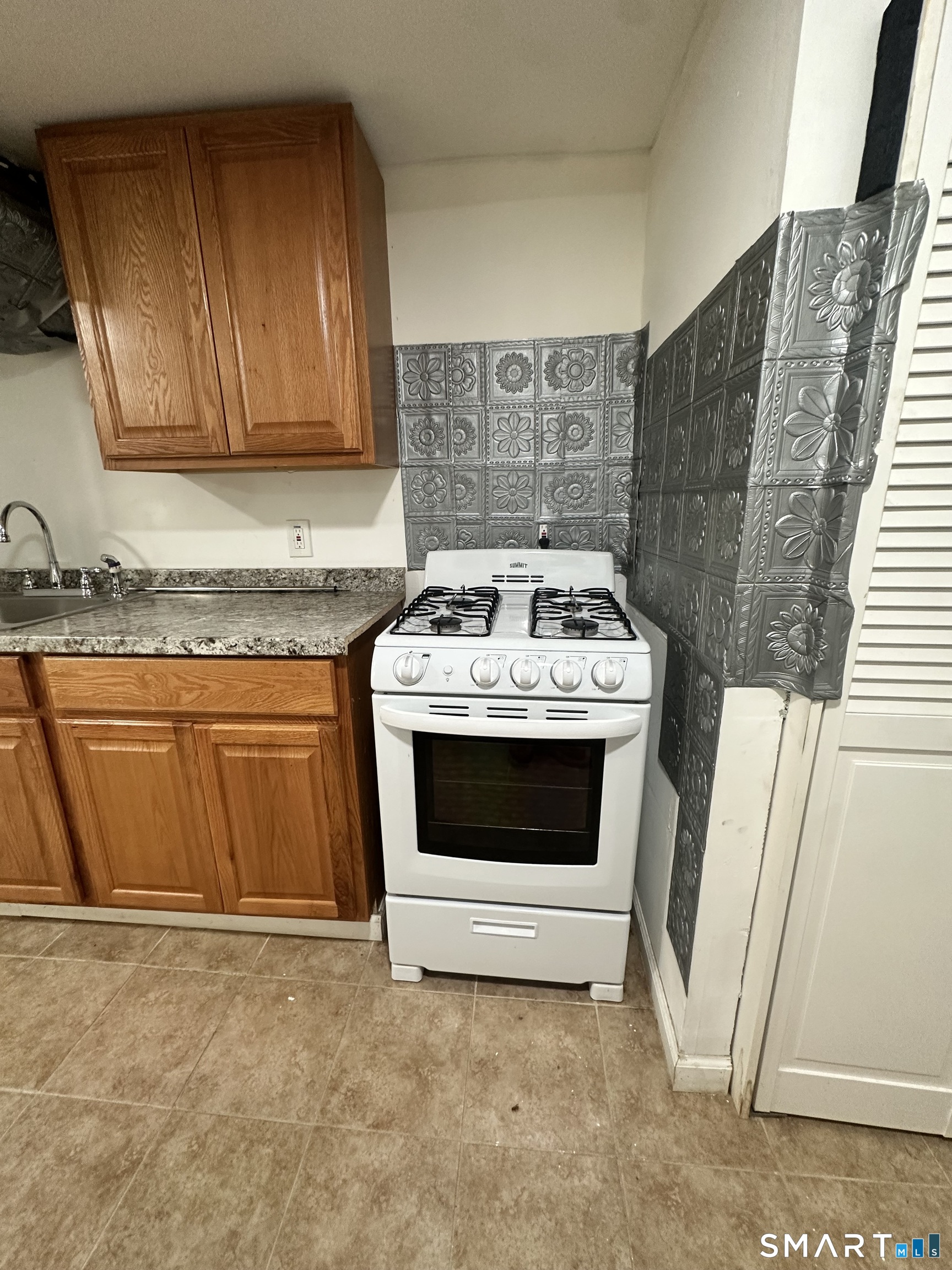 302 Dover Street Bridgeport, CT 06610 - Photo 39 of 40 a white stove top oven sitting inside of a kitchen