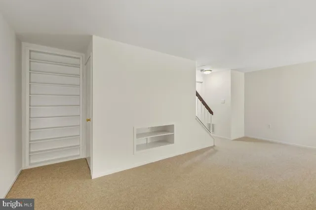 a view of a storage room with furniture and a kitchen view