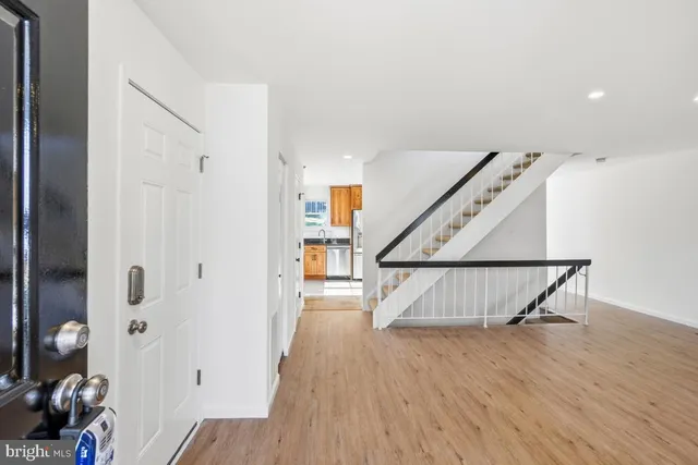 a view of entryway with wooden floor and stairs