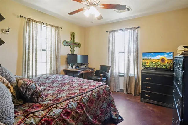 a bedroom with a bed and a tv