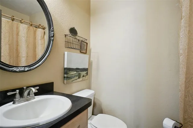 a bathroom with a sink a mirror and a toilet