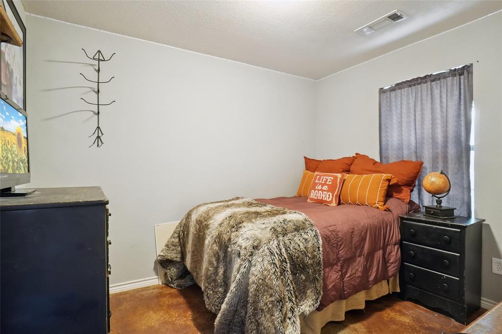 2454 Decatur Tx 76234 Decatur, TX 76234 - Photo 18 of 35 a bedroom with a bed and cabinets