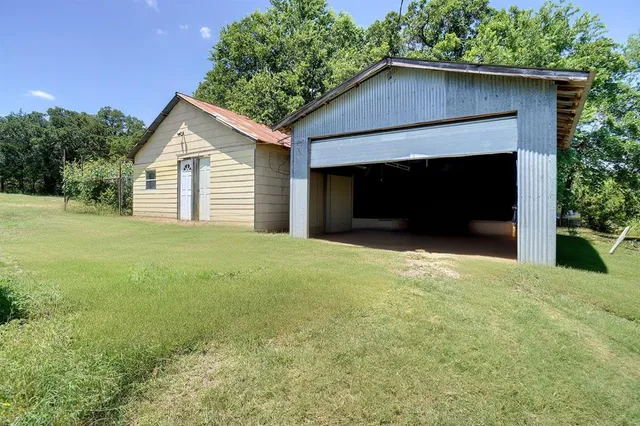 a view of a house with a yard and garage