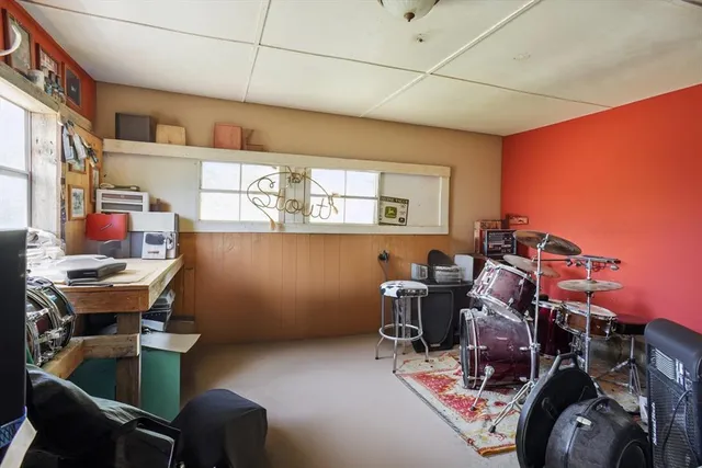a room with furniture and musical instruments