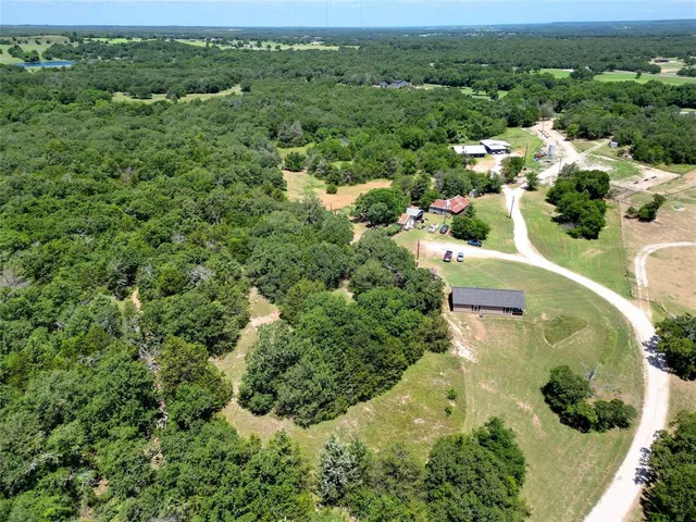 an aerial view of a house with a yard
