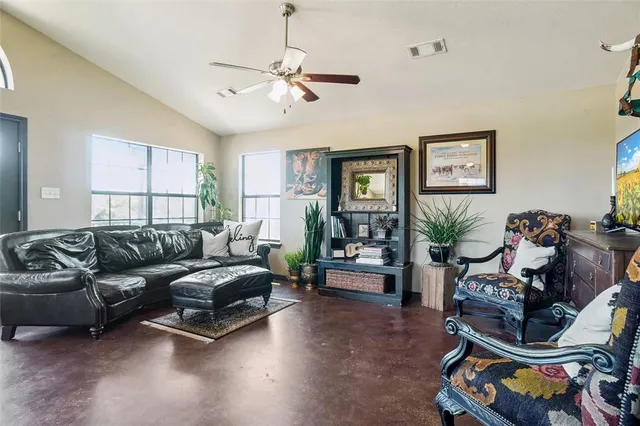 a living room with furniture a window and a flat screen tv