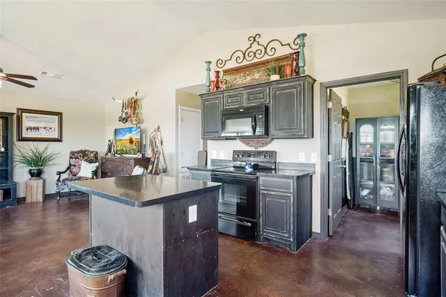 a kitchen with a sink and a stove top oven