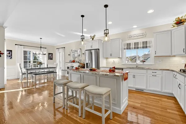 a kitchen with stainless steel appliances kitchen island granite countertop a sink and cabinets