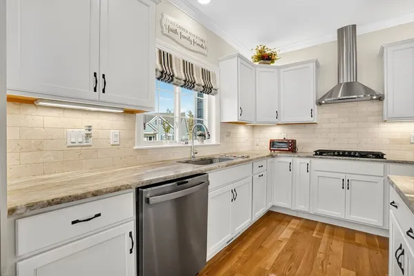 a kitchen with granite countertop stainless steel appliances sink and cabinets