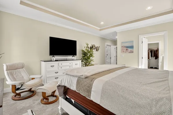 a bedroom with furniture and a flat screen tv