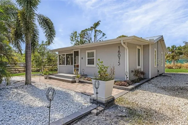 a view of a house with backyard and sitting area