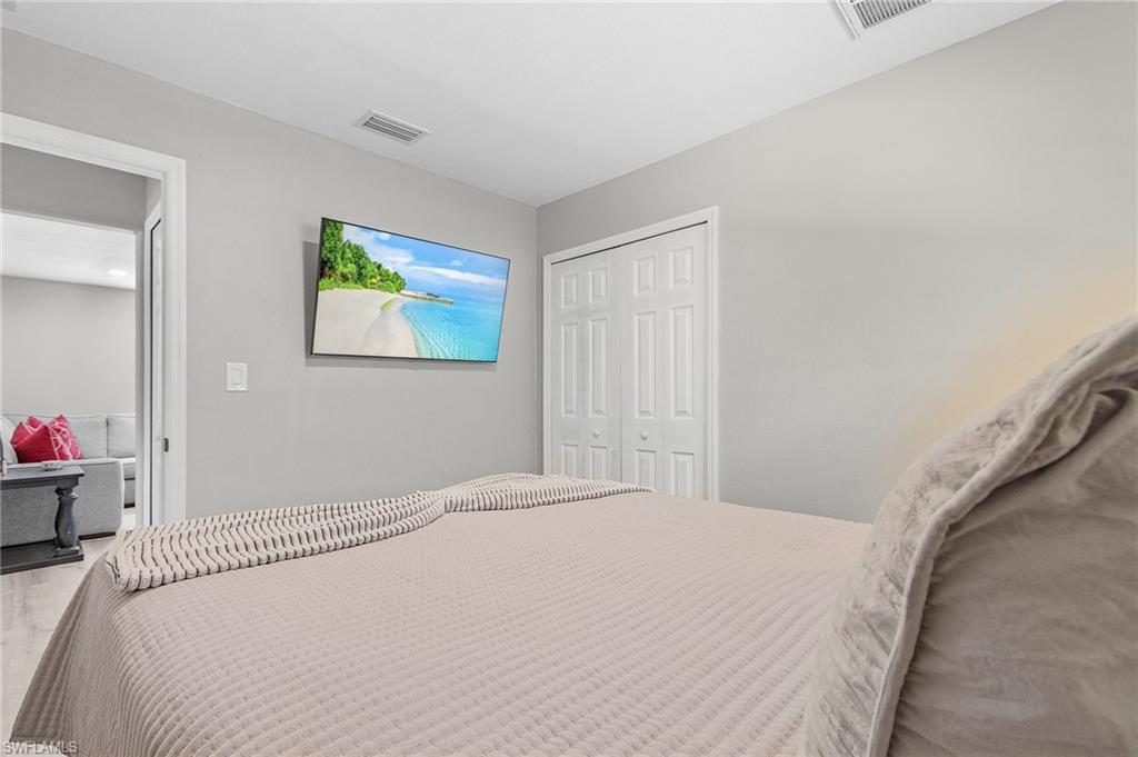 16075 Quail Trail Bokeelia, FL 33922 - Photo 13 of 24 a bedroom with a bed and a window