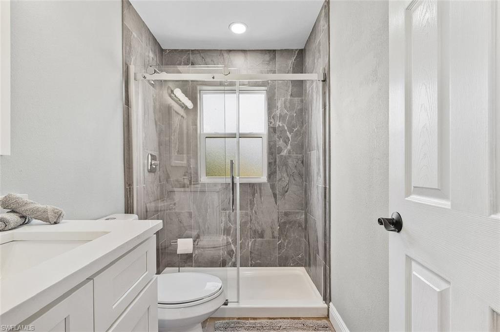 16075 Quail Trail Bokeelia, FL 33922 - Photo 14 of 24 a bathroom with a shower a toilet and a sink