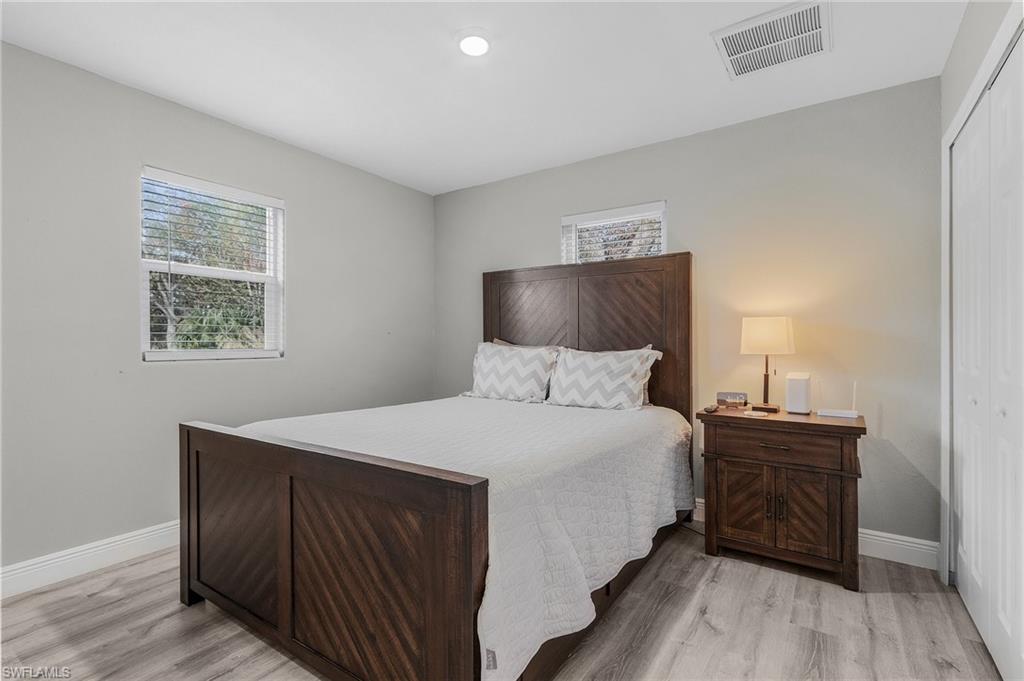 16075 Quail Trail Bokeelia, FL 33922 - Photo 17 of 24 a bedroom with a bed and a night stand