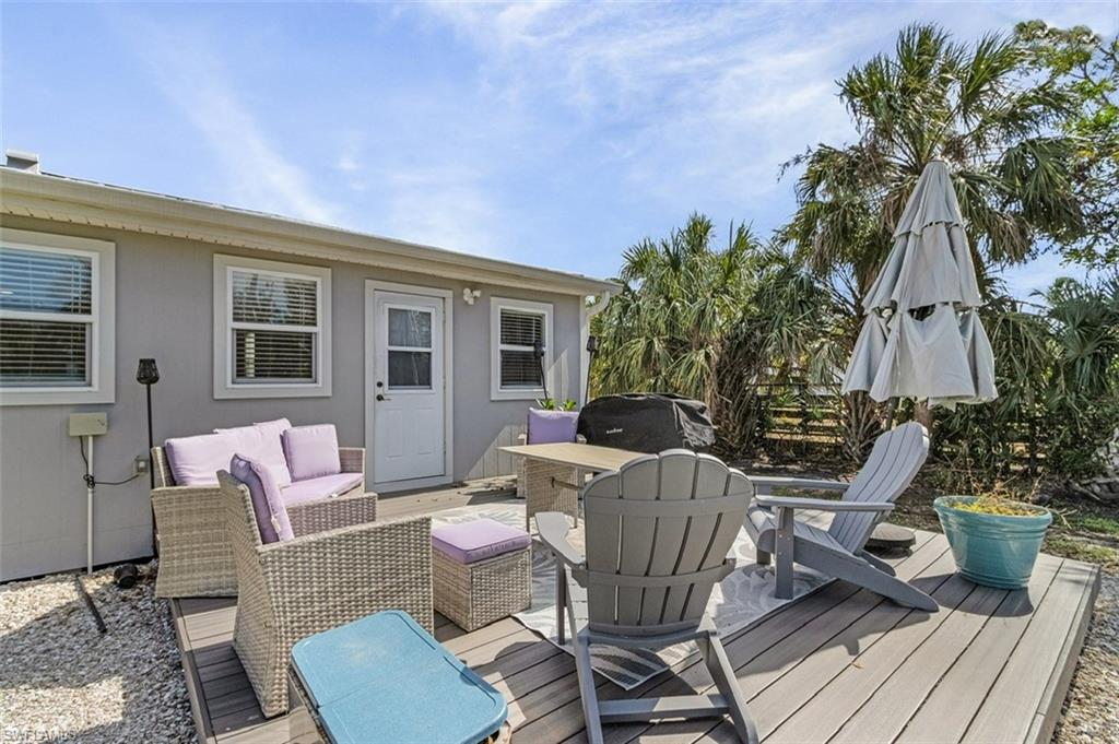 16075 Quail Trail Bokeelia, FL 33922 - Photo 21 of 24 a view of a house with patio outdoor seating