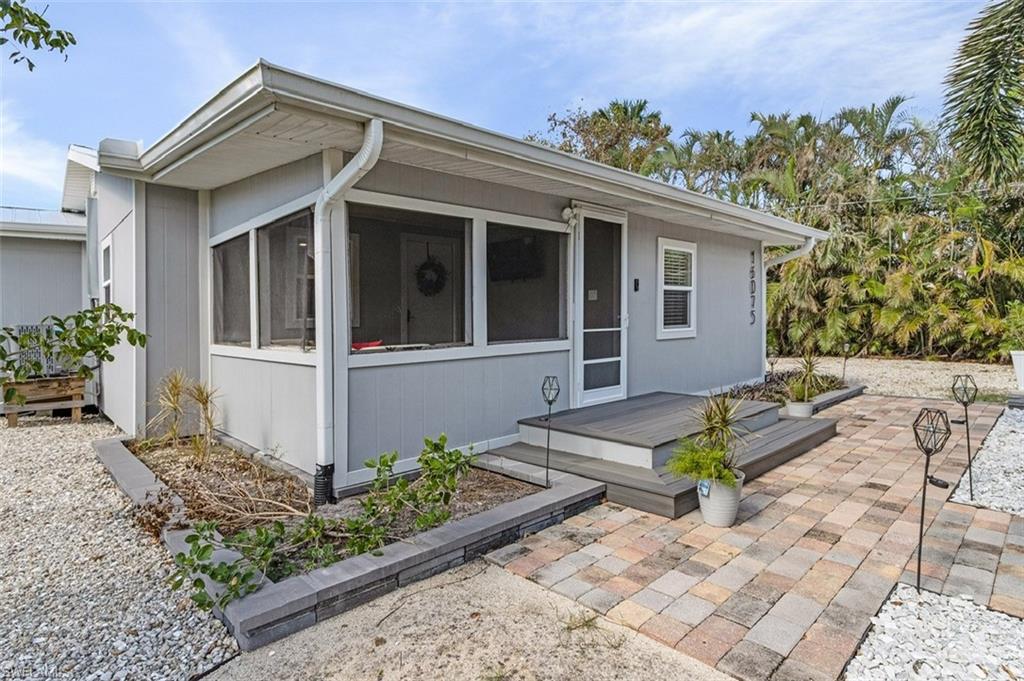 16075 Quail Trail Bokeelia, FL 33922 - Photo 3 of 24 a front view of a house with a garden