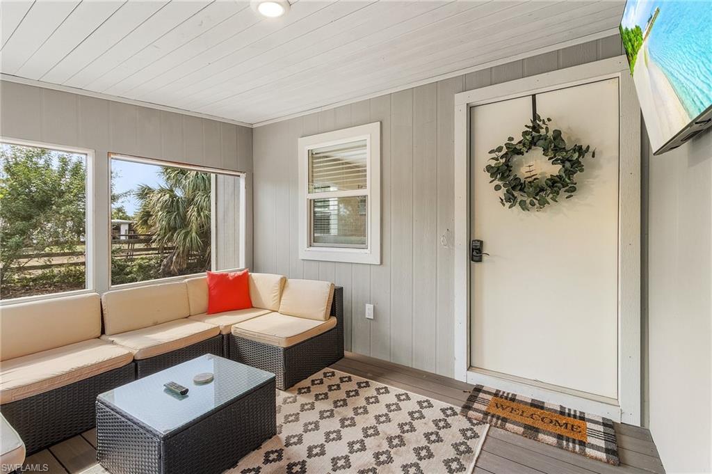 16075 Quail Trail Bokeelia, FL 33922 - Photo 4 of 24 a living room with furniture and a window