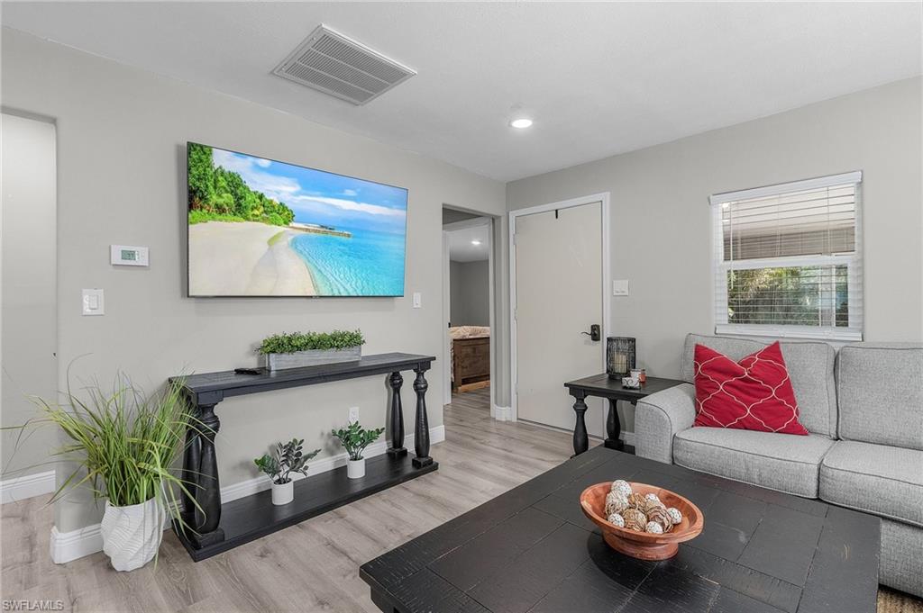 16075 Quail Trail Bokeelia, FL 33922 - Photo 5 of 24 a living room with furniture and a wooden floor