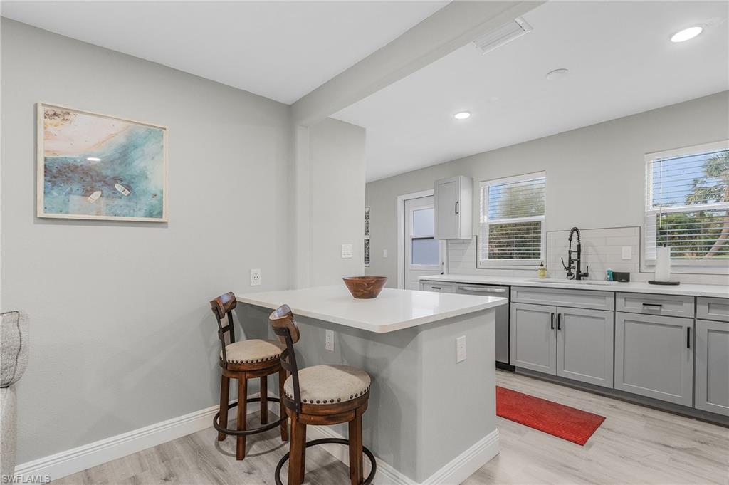 16075 Quail Trail Bokeelia, FL 33922 - Photo 7 of 24 a kitchen with a sink cabinets and window