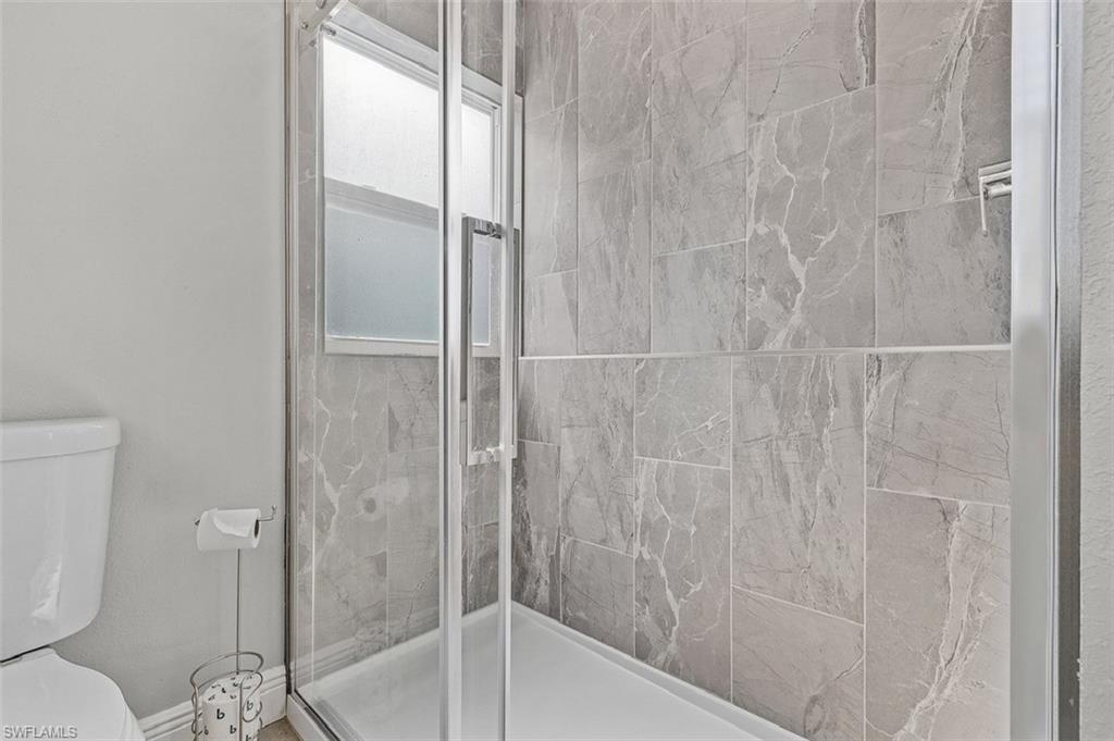 16075 Quail Trail Bokeelia, FL 33922 - Photo 10 of 24 a bathroom with a shower and toilet