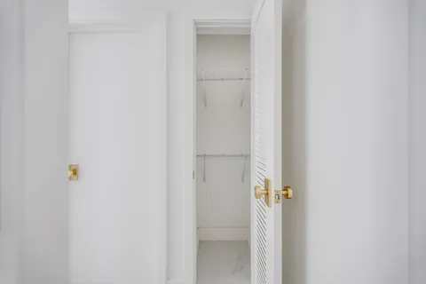 a view of a kitchen with a large window and a kitchen view
