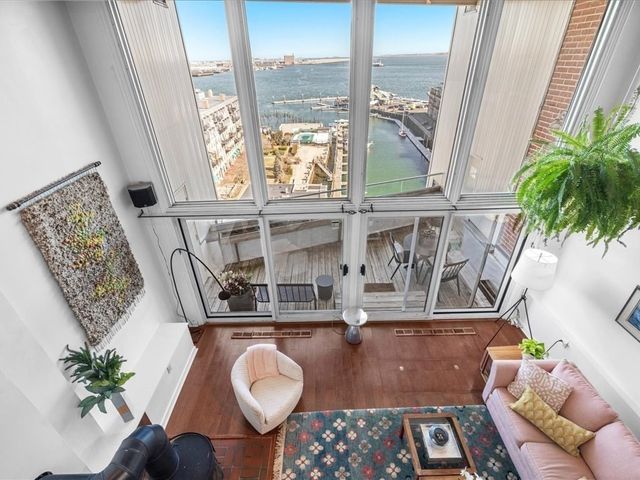 a living room with furniture and a floor to ceiling window