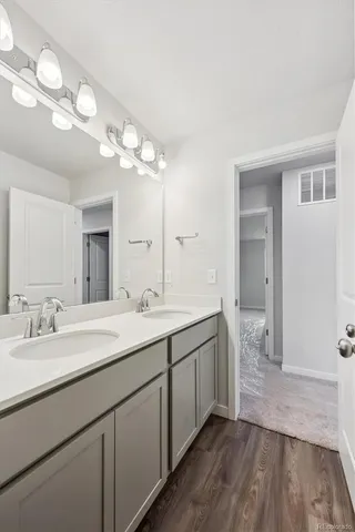 a spacious bathroom with a double vanity sink and a mirror
