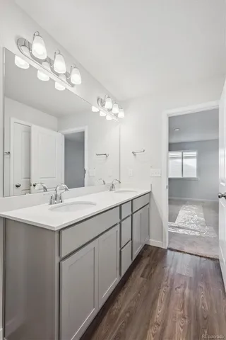 a spacious bathroom with a double vanity sink and a mirror