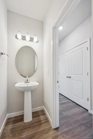 a bathroom with a sink toilet and mirror
