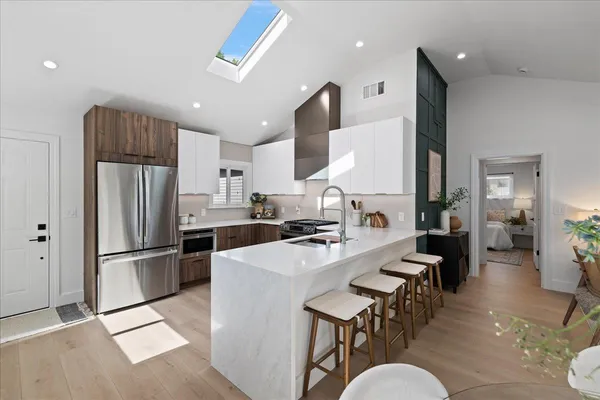 a large kitchen with a table and chairs