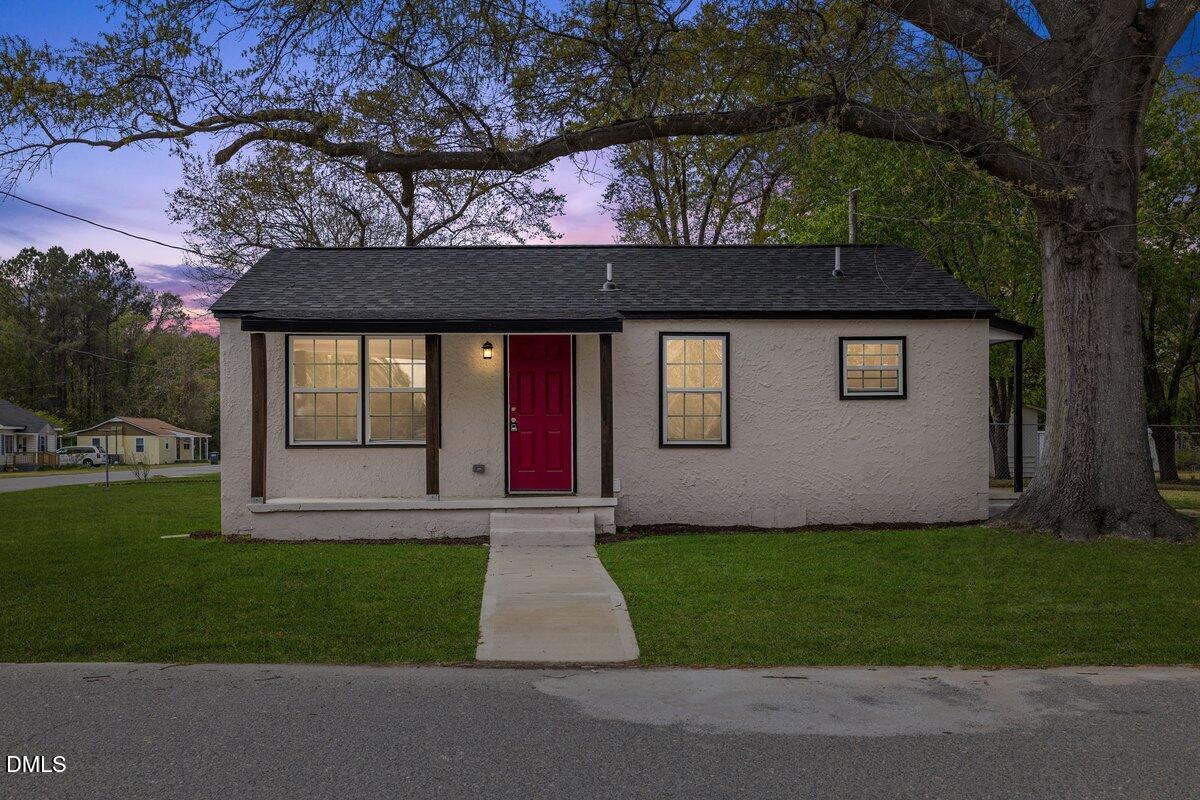 601 Temple Street Selma, NC 27576 - Photo 1 of 13 a front view of a house with a garden and yard