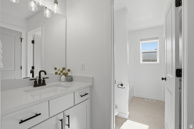 11531 Engelmann Drive Draper, UT 84020 - Photo 22 of 31 Bathroom featuring a single vanity with white cabinetry, a solid surface countertop, and a dark bronze faucet