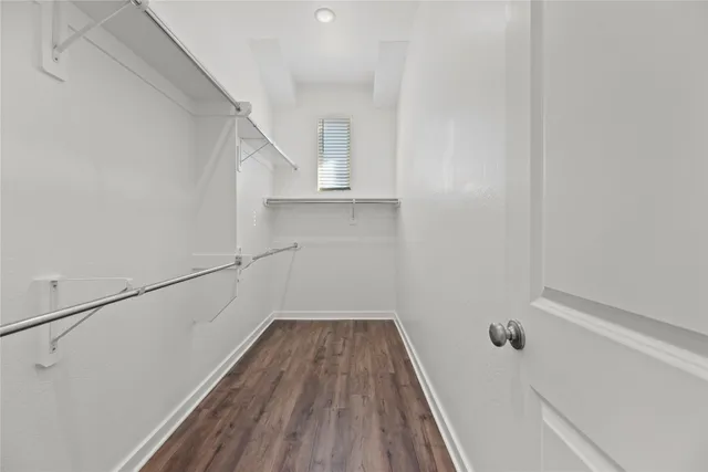 a view of a hallway with wooden floor and entryway