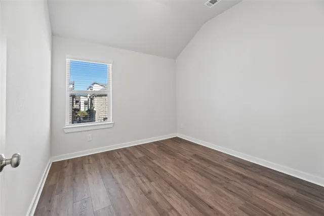 a view of a room with wooden floor and windows